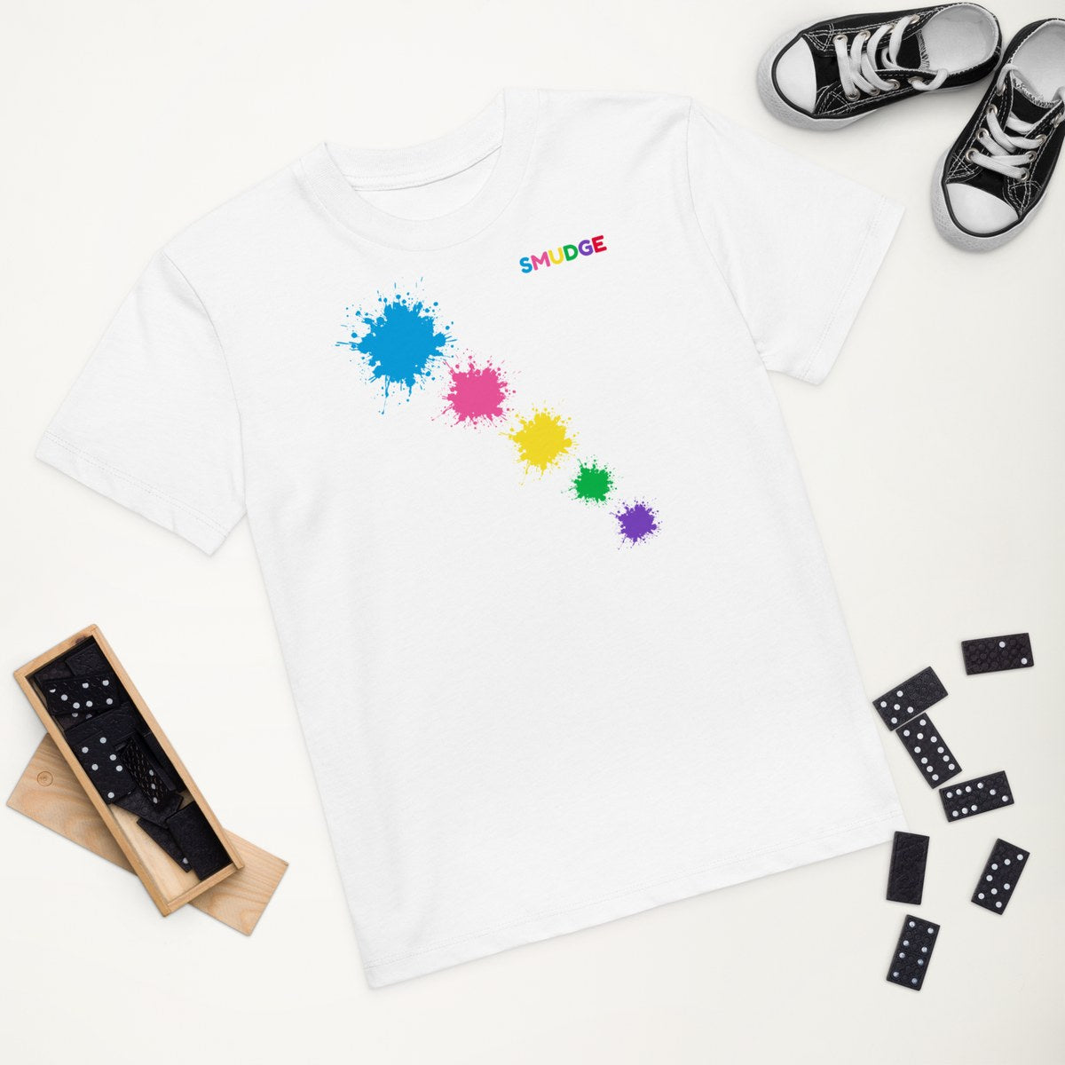 White organic kids' T-shirt with the Shoulder Trail design, styled flat lay