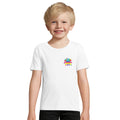 Boy wearing the white organic kids' T-shirt with a small SMUDGE splash badge at the top right of the chest