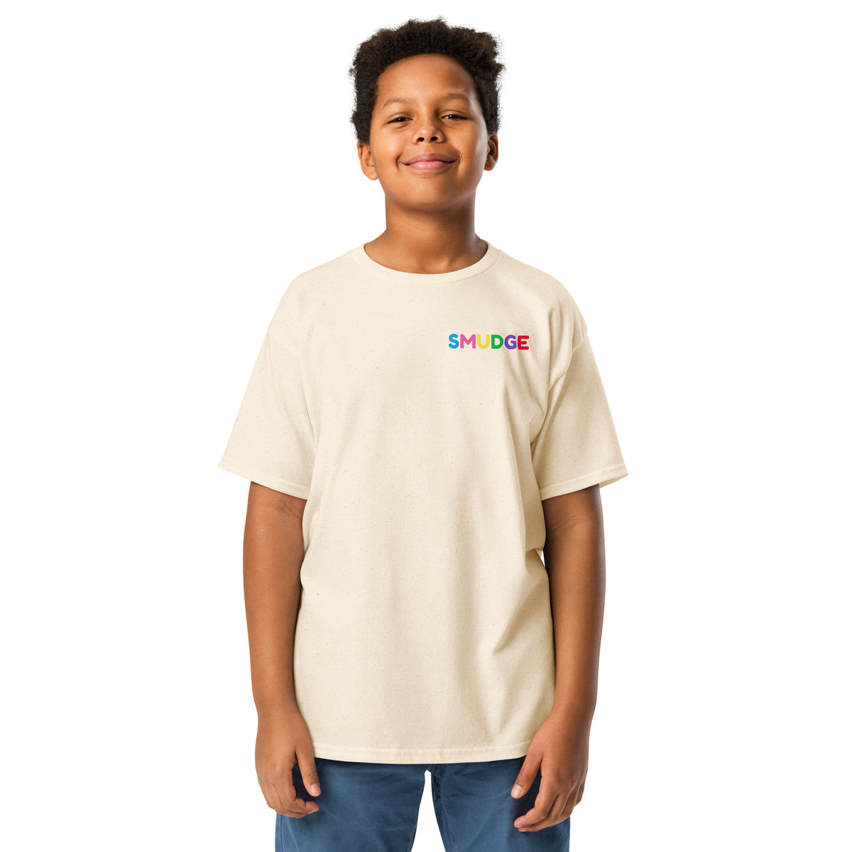 Boy wearing the cream youth T-shirt with a small SMUDGE wordmark at the top right of the chest