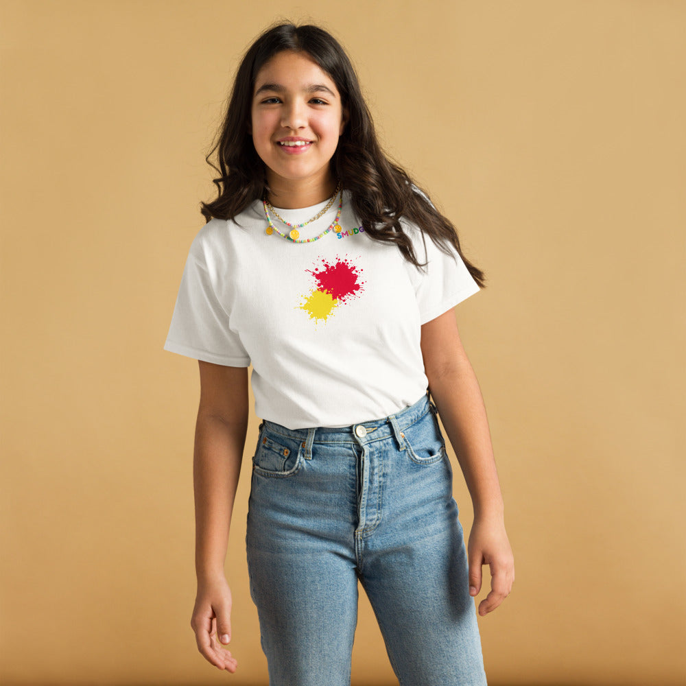 Child wearing a white SMUDGE youth t-shirt with the Red and Yellow Front Pair design, front view, studio backdrop