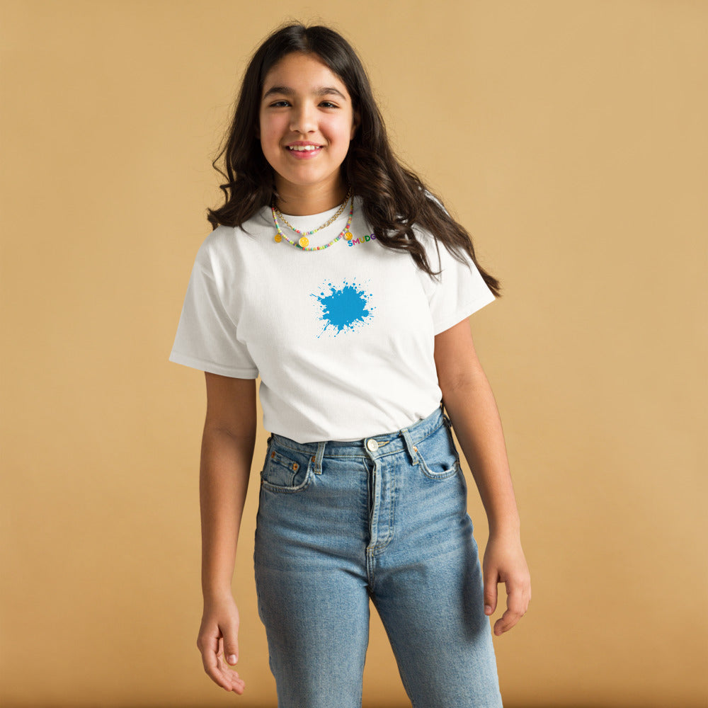 Child wearing a white SMUDGE youth t-shirt with the Cyan Splash design, front view, studio backdrop