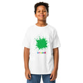 Boy wearing a white youth T-shirt with a green paint splat and SMUDGE wordmark on the chest