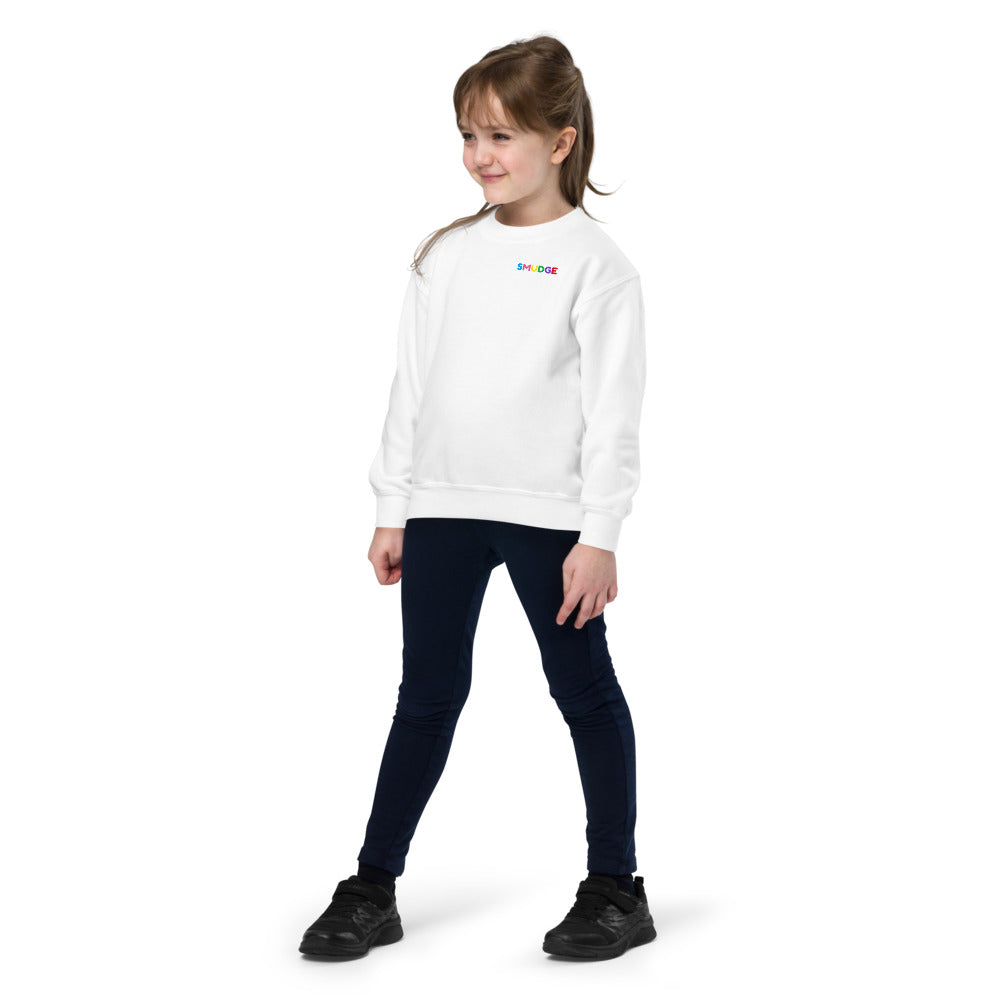 Child wearing a white SMUDGE youth sweatshirt with the Pink and Yellow Back Pair design, front view